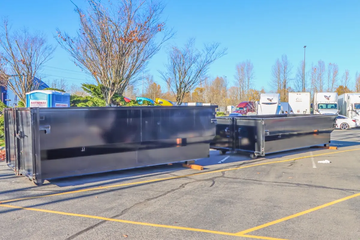 Professional dumpster rental service with roll-off container on residential driveway in Ormond Beach